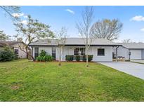 Charming single-story home boasts a well-maintained lawn and updated exterior paint at 3141 Loomis Dr, New Port Richey, FL 34655
