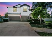 Beautiful two-story home with a well-manicured lawn, a three-car garage, and an inviting facade at 3555 Bracknell Ct, Land O Lakes, FL 34638