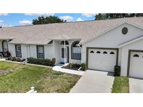 Charming single story home with well-maintained lawn and two-car garage at 4030 Casa Del Sol Way, New Port Richey, FL 34655
