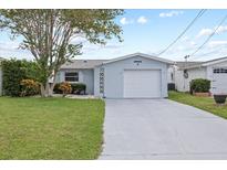 Charming single-story home features a well-manicured lawn and attached one-car garage at 5106 Blue Heron Dr, New Port Richey, FL 34652