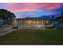 Charming single-story home with a well-maintained lawn and a screened front porch, perfect for enjoying the outdoors at 7321 Parrot Dr, Port Richey, FL 34668