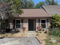 Charming single story home featuring a covered entry and meticulously maintained landscaping at 947 Village Dr, Brooksville, FL 34601