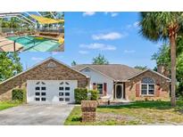 Charming single-story brick home featuring an attached two-car garage and a screened-in pool area at 13469 Pia Ct, Spring Hill, FL 34609