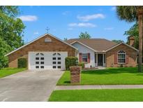 Charming brick home with two-car garage and well-manicured lawn in a suburban setting at 13469 Pia Ct, Spring Hill, FL 34609