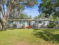 Charming single-story home with well-manicured lawn and mature trees offering shade at 196 Lark Ave, Brooksville, FL 34601