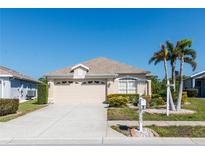 Charming single-story home featuring a well-manicured lawn, two-car garage and inviting curb appeal at 2325 Pleasant Hill Ln, Holiday, FL 34691