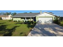 Charming single-story home with a well-manicured lawn and a two car garage at 273 Gulfport Ln, Spring Hill, FL 34608