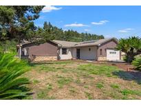 Charming single story home featuring wood paneled and stone exterior with a well maintained lawn, and attached garage at 3029 Harrow Rd, Spring Hill, FL 34606