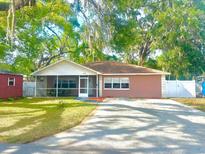 Charming single-story home featuring a spacious yard and mature trees, plus driveway and lawn at 37733 14Th Ave, Zephyrhills, FL 33542