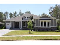 Charming single-story home featuring a manicured lawn, stone accents, and a welcoming front entrance at 6063 Dusk Rose Ln, Brooksville, FL 34601