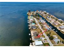 Aerial view of waterfront homes along a narrow canal in a coastal community at 6622 Seaview Blvd, Hudson, FL 34667
