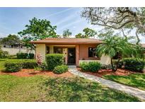 Inviting single-story home featuring neat landscaping, a walkway, and a well-maintained lawn at 7529 Greystone Dr # A, Hudson, FL 34667