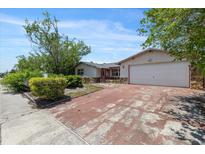 Charming single-story home with a two-car garage and a well-maintained front yard, offers classic curb appeal at 9001 Lido Ln, Port Richey, FL 34668
