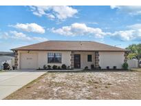 Charming single-story home featuring a well-manicured lawn and an attached one-car garage at 9100 Whitman Ln, Port Richey, FL 34668