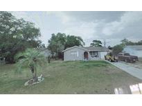 Charming single-story home featuring a spacious front yard and a long driveway at 10347 Caspian St, Spring Hill, FL 34608