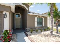 Charming home featuring well-manicured landscaping, a welcoming entrance, and stone accents for added curb appeal at 18353 Briar Oaks Dr, Hudson, FL 34667