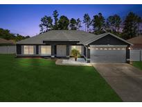 Charming single-story home with a well-manicured lawn and attached two-car garage at 5341 Birchwood Rd, Spring Hill, FL 34608