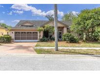 Charming single-story home features a two-car garage and mature landscaping, enhancing its curb appeal at 5638 Hereford Dr, New Port Richey, FL 34655