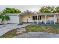 Charming single-story home with a well-manicured lawn and a welcoming front porch at 7235 Astor Dr, New Port Richey, FL 34652