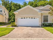 Exterior shot of garage with brick driveway on a sunny day at 7616 Wimpole Dr, New Port Richey, FL 34655