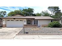 Charming single-story home features a two-car garage and low-maintenance landscaping in the front yard at 7715 Gulf Highlands Dr, Port Richey, FL 34668