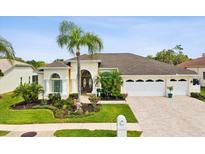 Charming single-story home featuring a well-manicured lawn and a spacious three-car garage at 8137 Morning View Dr, Hudson, FL 34667