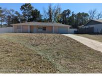 Charming single-story home with an attached garage and a well-manicured front yard at 12116 Lamont Dr, Spring Hill, FL 34608