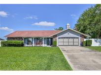 Charming single-story home with well-maintained landscaping and a two-car garage at 12191 Monarco Ln, Spring Hill, FL 34609