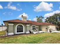 Charming single-story home with a well-maintained lawn and cozy front patio area at 13373 Lawrence St, Spring Hill, FL 34609