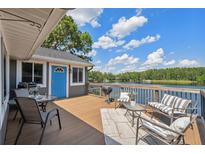 Relax on the spacious deck with lake views, outdoor seating, and a barbecue grill at 1700 Beachway Ln, Odessa, FL 33556