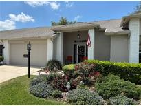 Charming single-story home featuring a landscaped front yard and covered entryway at 18027 Baywood Forest Dr, Hudson, FL 34667