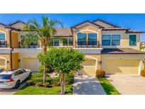 Charming two-story townhouse with well-manicured landscaping, a private balcony, and attached garage at 9103 Carolina Wren Dr, Tampa, FL 33626