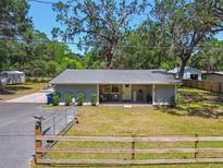 Charming single-story home with a well-manicured lawn and inviting front porch at 9226 Dan Lynn St, Brooksville, FL 34601