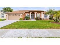 Charming single-story home with well-manicured lawn and welcoming front entrance at 12040 Penzance Ln, New Port Richey, FL 34654