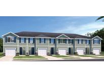 Beautiful townhomes with light green siding, dark trim and shutters, and manicured lawns at 20385 Lou Angela Ln, Lutz, FL 33558