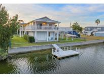 Waterfront home featuring a private dock, elevated deck, and boat parking, perfect for the avid boater at 3340 Oleander Dr, Hernando Beach, FL 34607