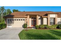 Charming single Gathering home with a well manicured lawn and lovely landscaping at 5931 Precious View Ct, New Port Richey, FL 34655