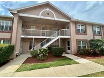 Charming condo exterior with well-maintained landscaping and a welcoming staircase at 6338 Spring Flower Dr # 15, New Port Richey, FL 34653