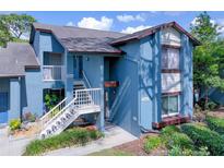 Inviting condo with a blue exterior and a well-manicured lawn at 7662 St Andrews Blvd, Weeki Wachee, FL 34613