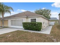 Charming single Gathering home with a well maintained lawn and an attached two car garage at 9048 Southern Charm Cir, Brooksville, FL 34613