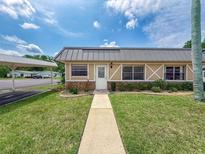 Charming single story home boasts stone accents and a metal roof for lasting beauty at 11601 Bayonet Ln # 163A2, New Port Richey, FL 34654