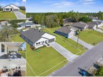 New construction homes feature modern exteriors with well-maintained lawns, long driveways, and beautiful landscaping at 14042 Amero Ln, Spring Hill, FL 34609