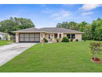 Charming home with a well-manicured lawn and a lovely front yard at 2122 Meadow Lark Rd, Spring Hill, FL 34608