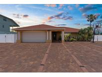 Inviting single-story home featuring a brick driveway, two-car garage, and well-maintained landscaping at 3361 Gulfview Dr, Hernando Beach, FL 34607