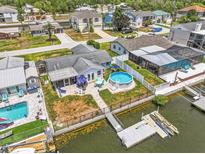 Stunning waterfront property with a backyard pool and a private dock for boating and enjoying the coastal lifestyle at 7626 Hatteras Dr, Hudson, FL 34667