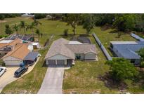 Aerial view of the property with a large, green lawn at 8126 Wooden Dr, Spring Hill, FL 34606