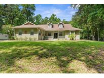 Charming single-story home with a spacious front yard and mature trees at 14145 Citrus Way, Brooksville, FL 34601
