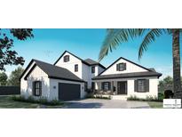 Stunning exterior elevation with modern design, featuring a two-car garage, covered porch, and sleek black and white accents at 5457 Creek Ridge Rd, Brooksville, FL 34601