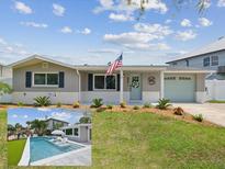 Charming single story home featuring manicured lawn, brick accents, tidy landscaping, and a quaint light-blue front door at 5512 Tropic Dr, New Port Richey, FL 34653
