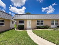 Charming single-story home with well-maintained lawn, white front door and neutral exterior color scheme at 11821 Boynton Ln, New Port Richey, FL 34654